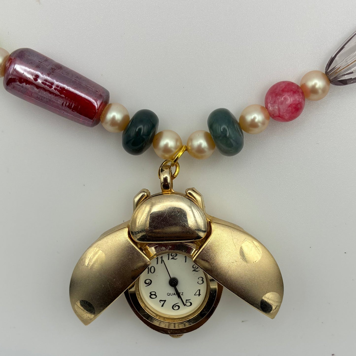 Handgemachte lange Halskette mit kleiner Uhr, Edelsteinen und bunten Perlen